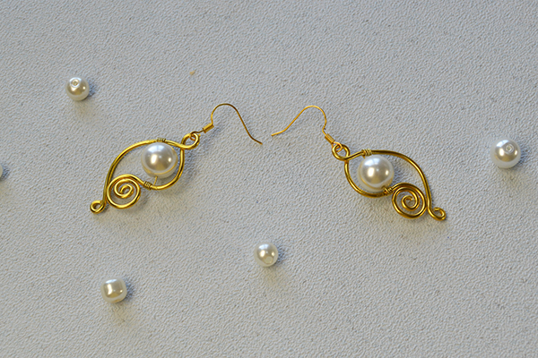 golden wire wrapped earrings with white pearl beads