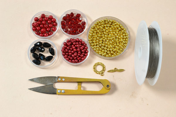 Supplies needed for the red pearl necklace with black glass beads: