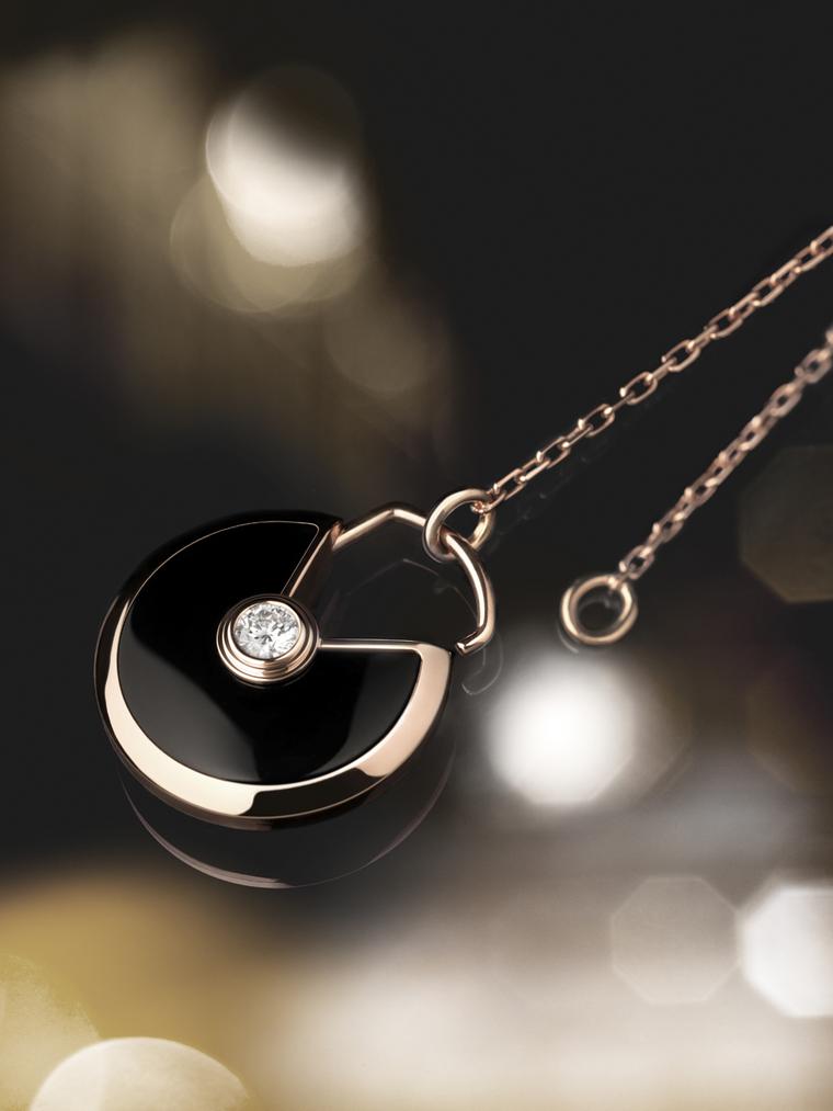 Amulette de Cartier small pink gold pendant with onyx surrounding a brilliant-cut diamond.