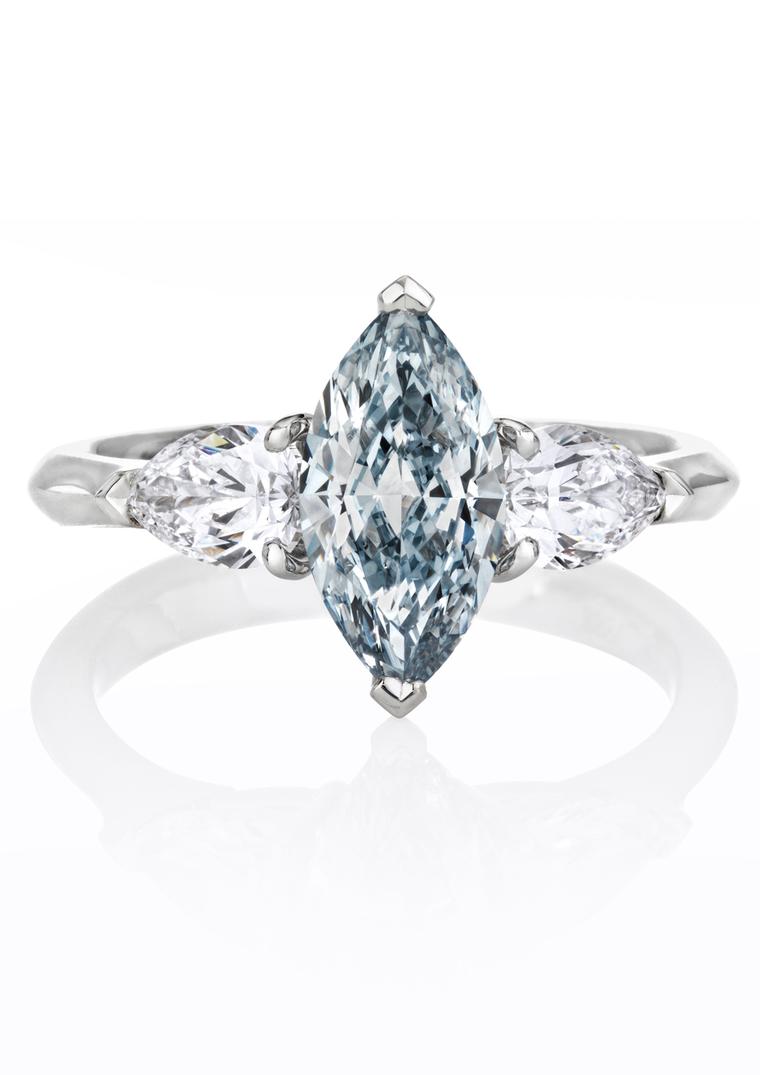 De Beers marquise-shaped blue diamond engagement ring flanked by white diamonds.