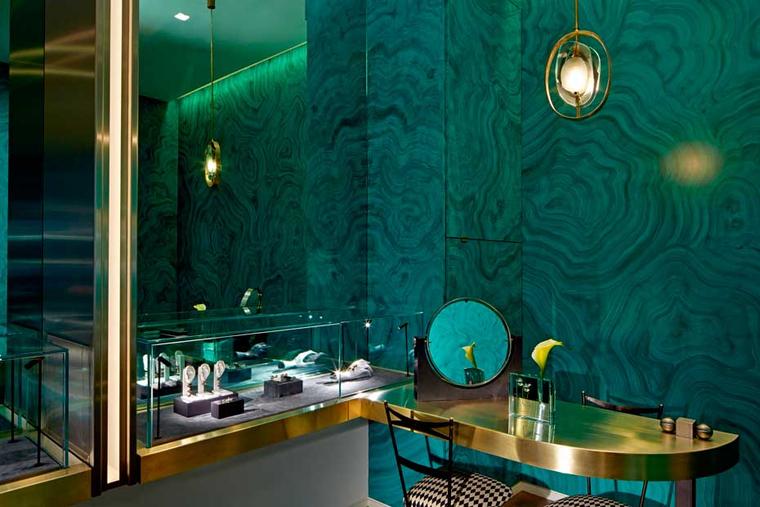 The walls of the boutique are lined in green mirrors, and elsewhere there is a mix of materials and textures including polished stainless steel, satin brass, fur and malachite green faux leather.