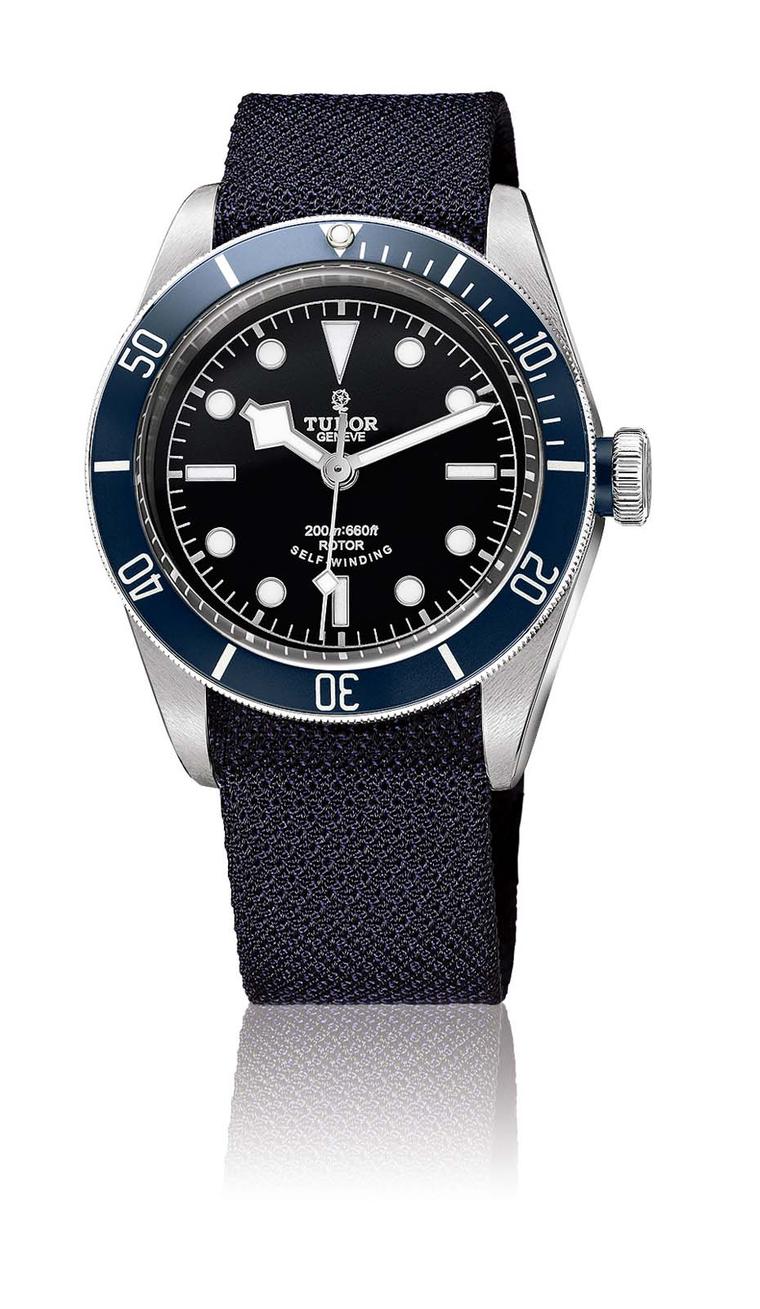 Tudor's Heritage Black Bay Marine Nationale dive watch features a rotating blue bezel and three straps, including a steel bracelet, leather strap and a black/blue textile strap.