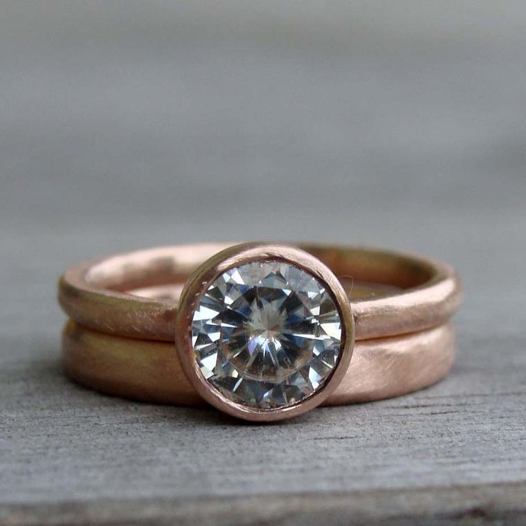 McFarland Designs engagement ring featuring a Forever Brilliant Moissanite stone with a recycled rose gold band and matching wedding ring.