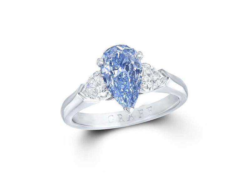 Graff 1.04ct Internally Flawless blue diamond engagement ring flanked by two pear-shaped white diamonds.