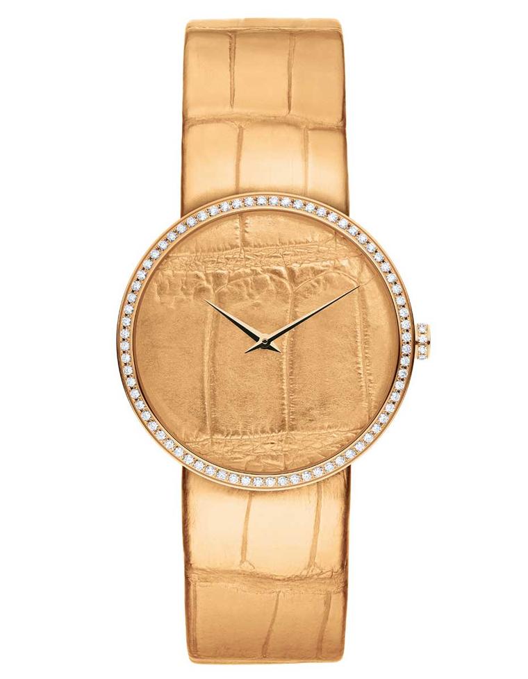La D de Dior Alligator watch in pink gold and diamonds. The dial is coated in pink gold and embossed with an alligator pattern, while the alligator strap is coated with pink gold leaf