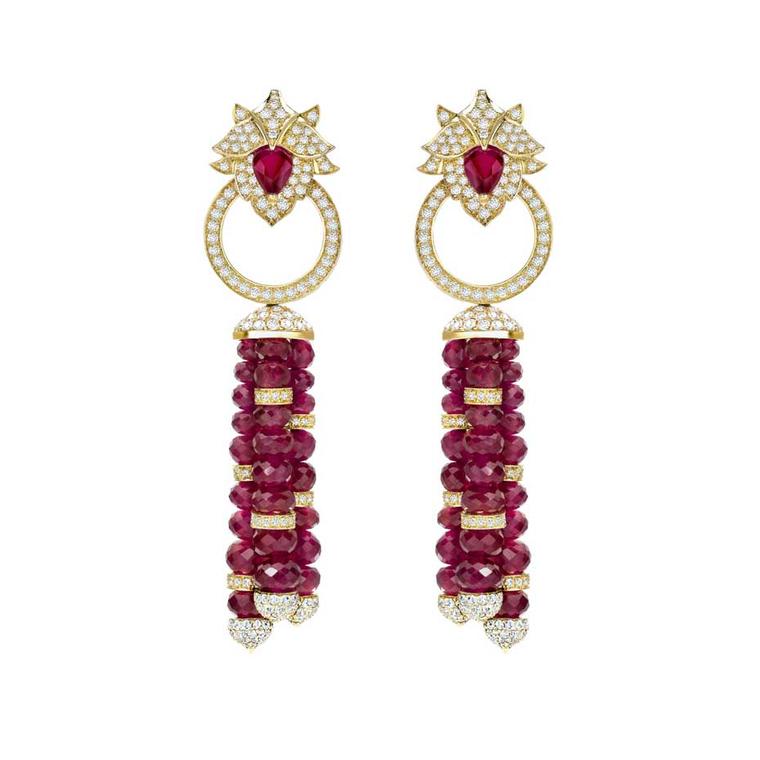 Delicate high jewellery Lotus ruby earrings from Asprey London feature a pavé diamond lotus flower motif in yellow gold at the ear and multi-faceted pear-shaped rubies on the tassels.