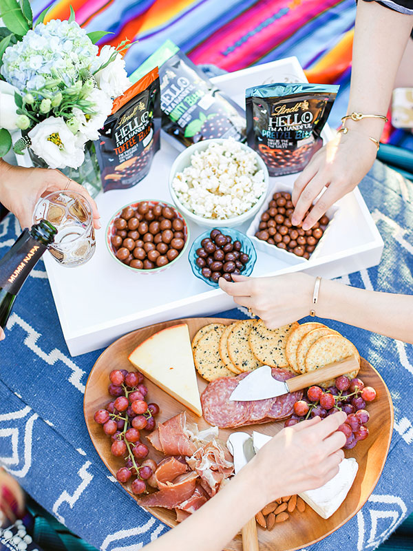 movie night essentials: champagne, popcorn, a cheese plate, and premium chocolate from Lindt HELLO Bites {yum}