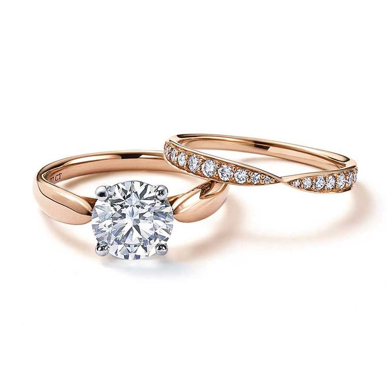 Tiffany Harmony solitaire diamond engagement ring in rose gold, with a matching rose gold wedding band with diamonds.