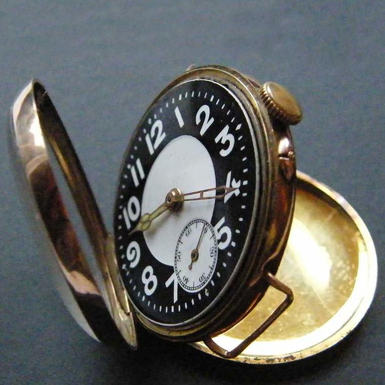 An English military watch from 1916, used by soldiers and pilots during WWI, that illustrates the transition from pocket watch to wristwatch, incorporating features of both.