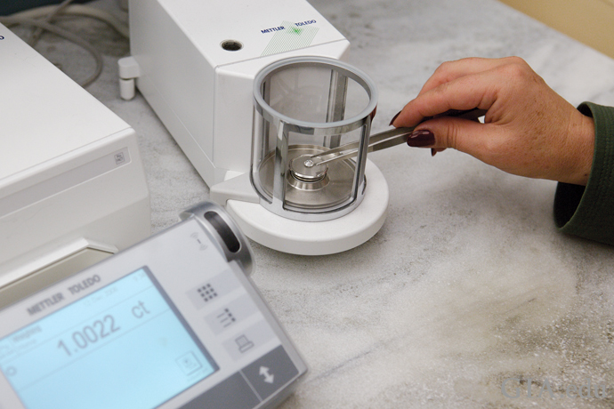 Diamonds being weighed on an electronic mirco-balance scale