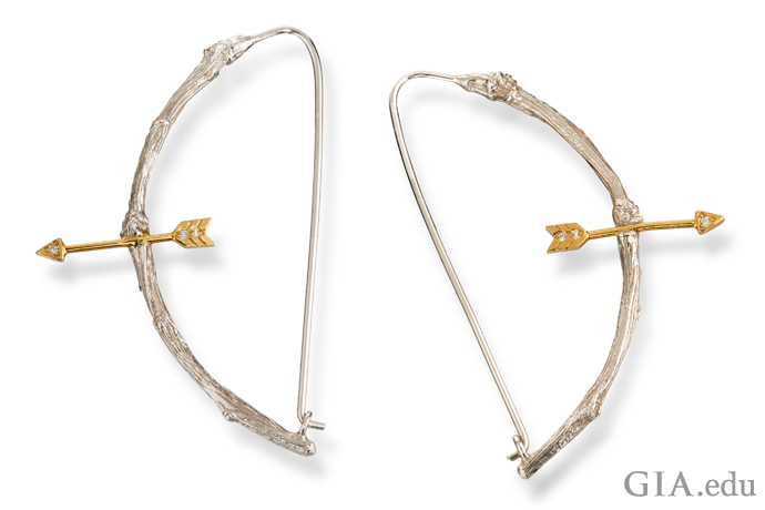 18K gold, sterling silver and diamond-accented earrings. The bow is carved to resemble pieces of knotted wood.