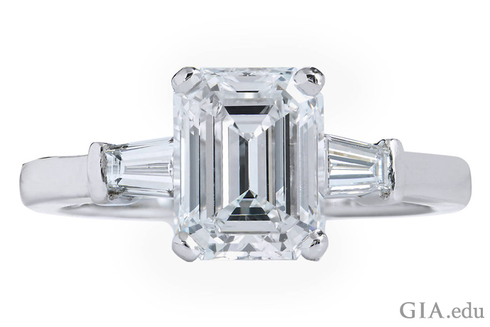 A 2.01 ct E-color emerald cut diamond flanked by two tapered baguette diamond accents