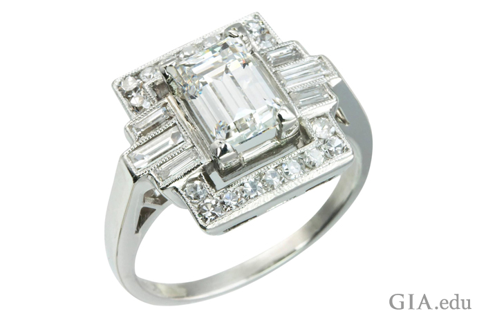 A 1.37 ct emerald cut Art Deco engagement ring accented with six baguette diamonds and 18 round brilliants