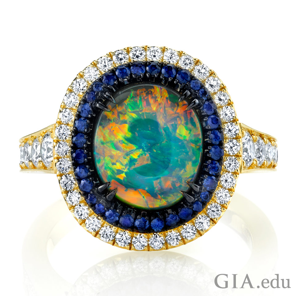 October birthstone ring featuring black opal, sapphire and diamonds set in 18k yellow gold with black rhodium