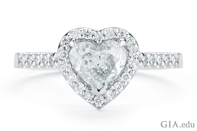 This beautiful platinum ring featuring a 1.25 ct heart-shaped diamond surrounded by pavé-set diamonds is sure to tell her you love her.