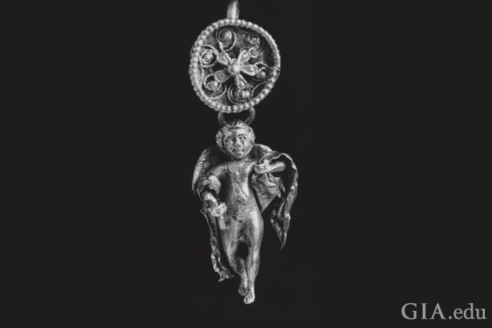 Eros as a young man decorates this pendant from ancient Greece (circa 300 – 400 BCE).