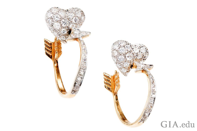 These 1.50 carats of diamond earrings set in 14K gold of arrows piercing hearts is a creative way to evoke Cupid. 