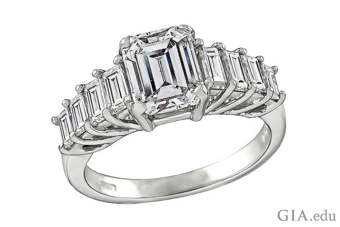 A 1.79 ct emerald cut engagement ring flanked by 0.70 carats of baguette cut diamonds 