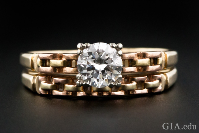 Gold “tank treads” are the dominant motif in this vintage engagement ring and wedding band from the Retro period.