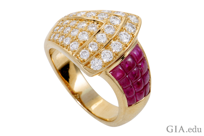 In this 18K gold contemporary re-creation of a Retro-style ring, approximately 0.90 carats of diamonds fan out to meet a field of invisibly set rubies totaling 2.23 carats.