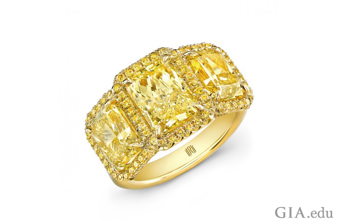 Three yellow radiant cut diamonds in this ring set with round yellow melee diamonds.