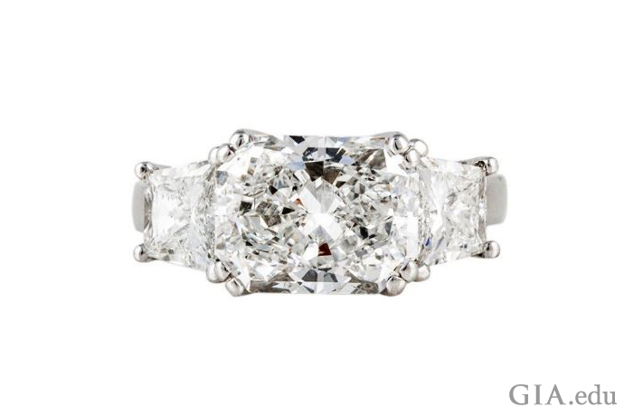 Magnificent ring has a 4.15 ct stone with trapezoid-cut side stones weighing another 1.25 ct.